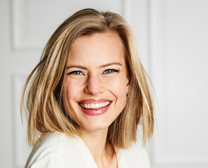 Smiling blonde woman with thick mid-length hair